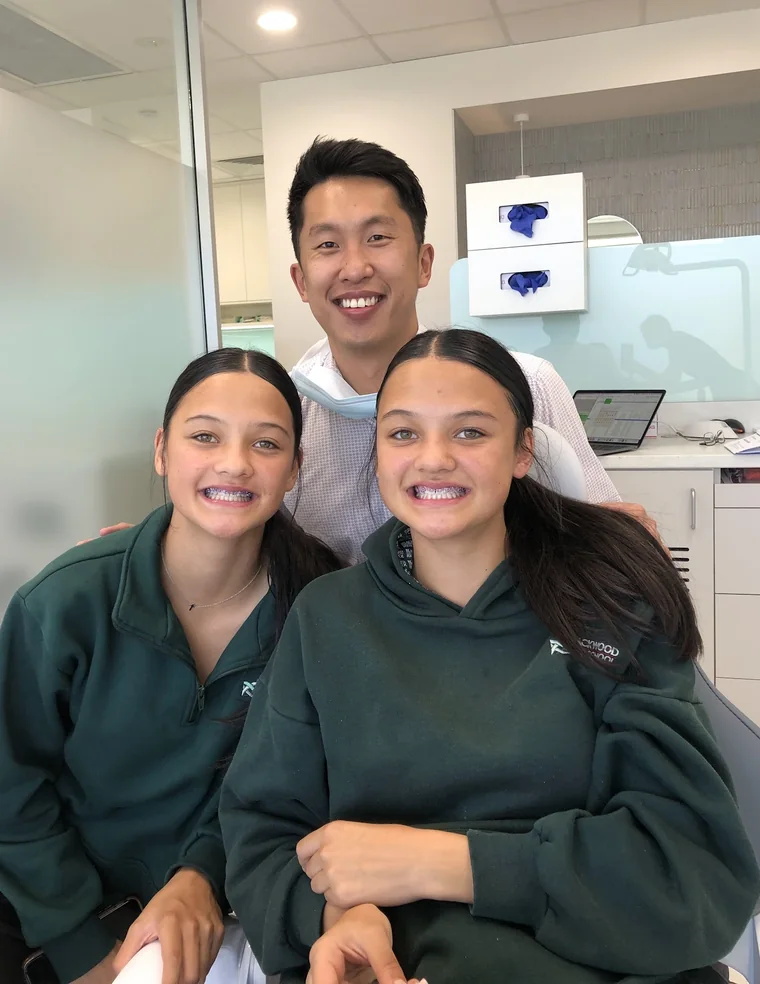 Dr Shaun Goh with two teenage Go Orthodontics patients showing their braces